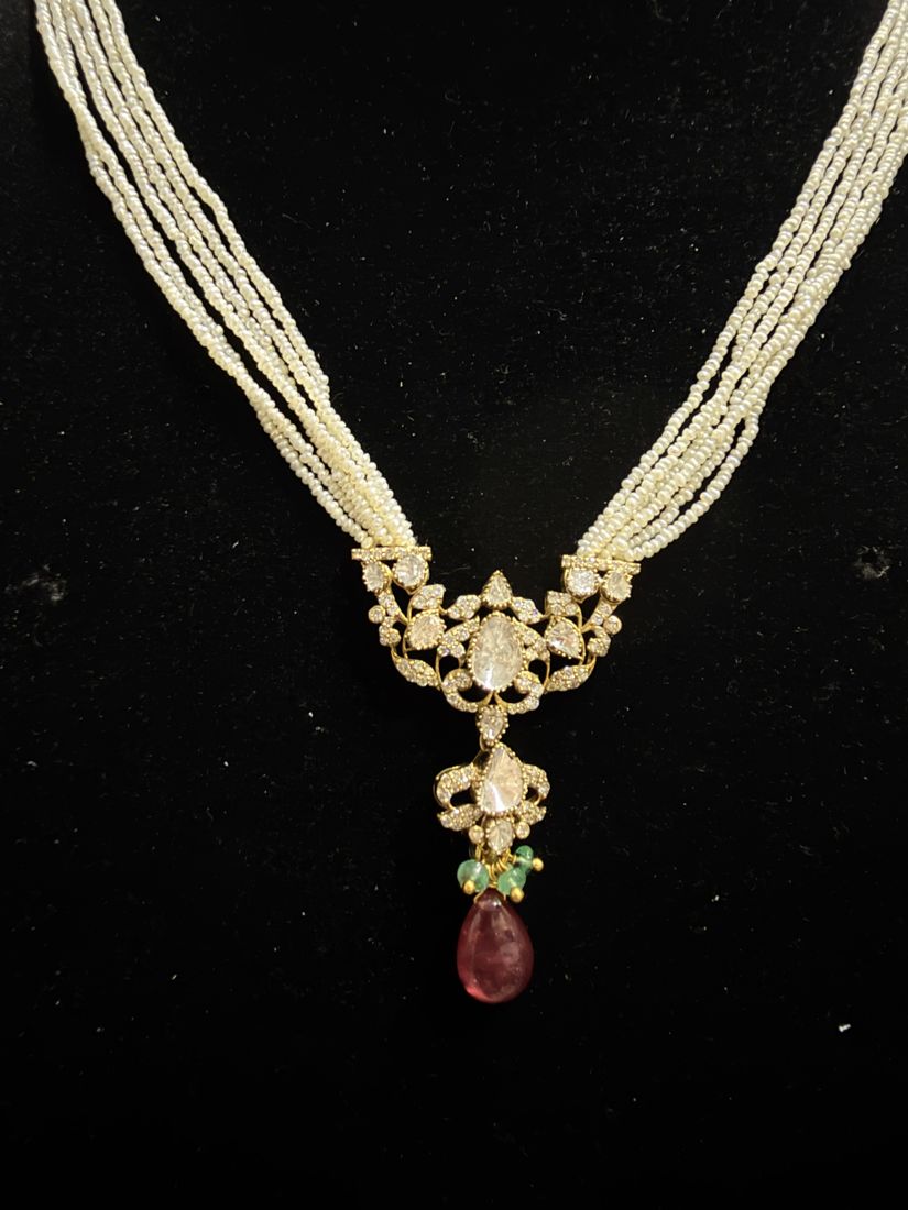 Diamond pendant on pearl strands